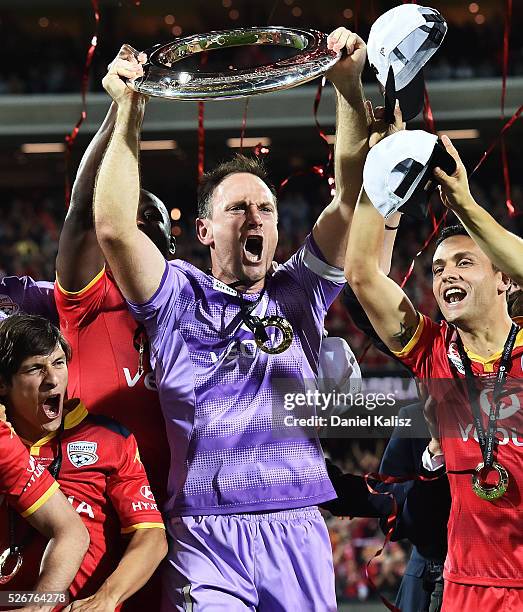 United goalkeeper Eugene Galekovic lifts the trophy after during the 2015/16 A-League Grand Final match between Adelaide United and the Western...