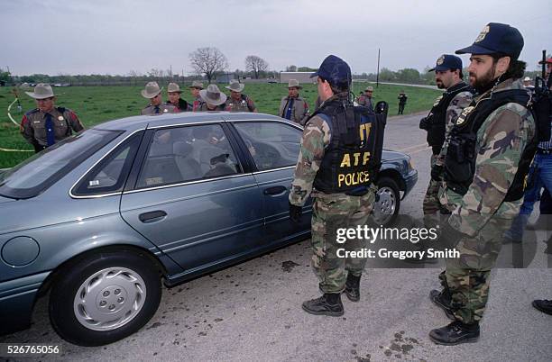 State troopers and members of the Bureau of Alcohol, Tobacco and Firearms stop a motorist during the 1993 Branch Davidian standoff near Waco, Texas....