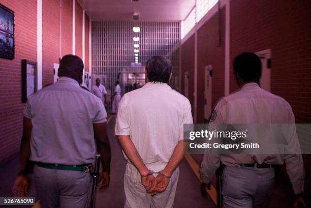 Guards escorts a death row prisoner at Ellis Unit in Huntsville, Texas. Since 1976, the state of Texas has lead the nation in prison executions.