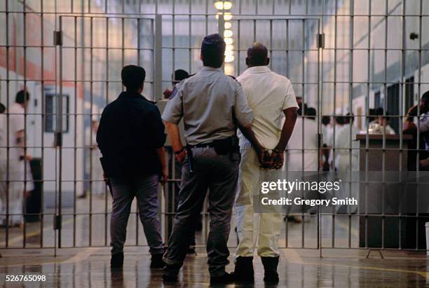 Guards escorts an inmate at prison in Huntsville, Texas. Texas has the largest prison system in the nation, with the town of Huntsville being home to...