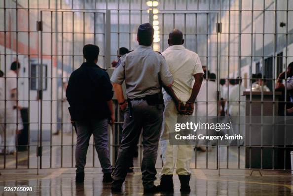 A guards escorts an inmate at prison in Huntsville, Texas. Texas has ...