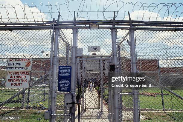 The entrance to Ellis Unit in Huntsville, Texas, is marked by a double fence, a locked gate, and razor wire. Texas has the largest prison system in...