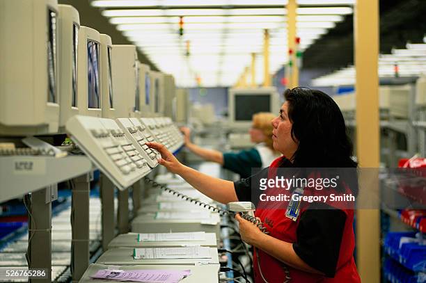 Woman tests Dell computers on an assembly line in Austin, Texas.