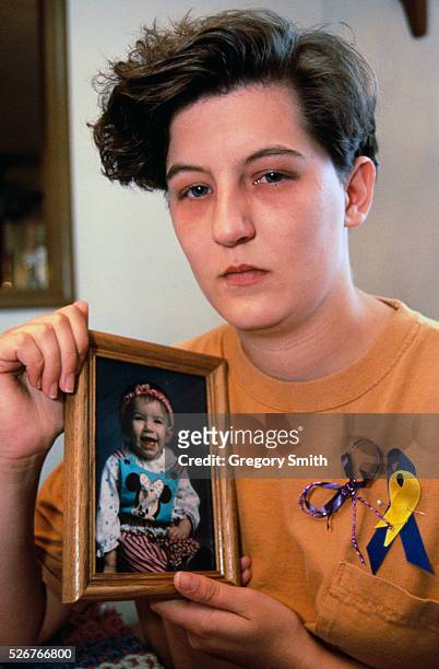 Ellen Almon holding a picture of daughter Baylee Almon killed durning the Oklahoma City federal building bombing .
