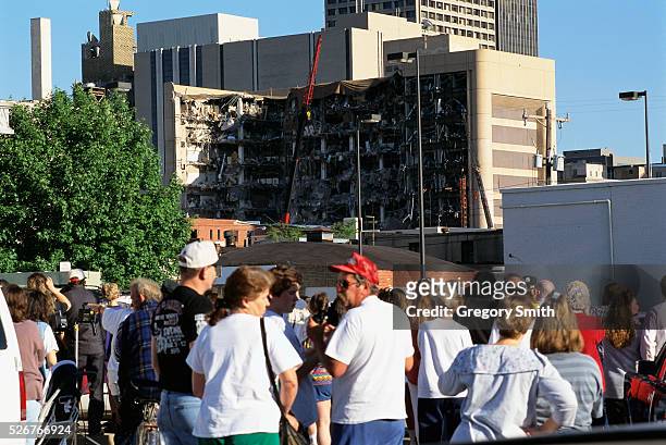 Crowd watches as investigators search the remains of the Alfred P. Murrah Building.