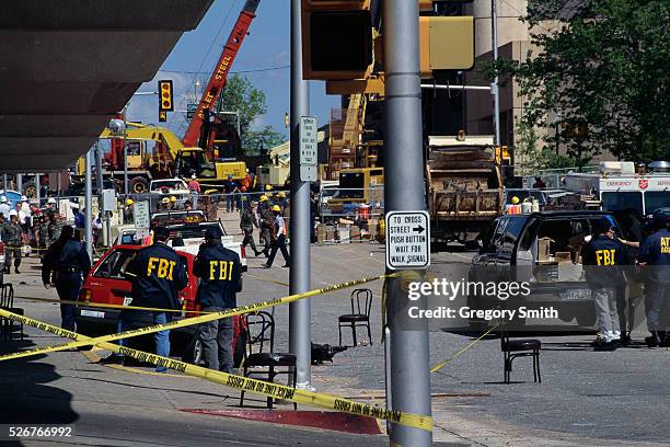 And ATF agents search a car transmission thrown by the explosion during the bombing of the Alfred P. Murrah Federal Building.