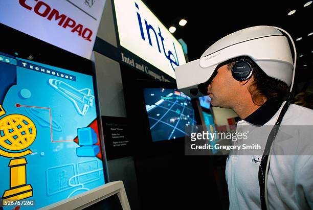 Person tests a virtual reality program at the Compaq Worldwide Technology Summit in Houston, Texas. The virtual reality unit uses a Compaq pentium...