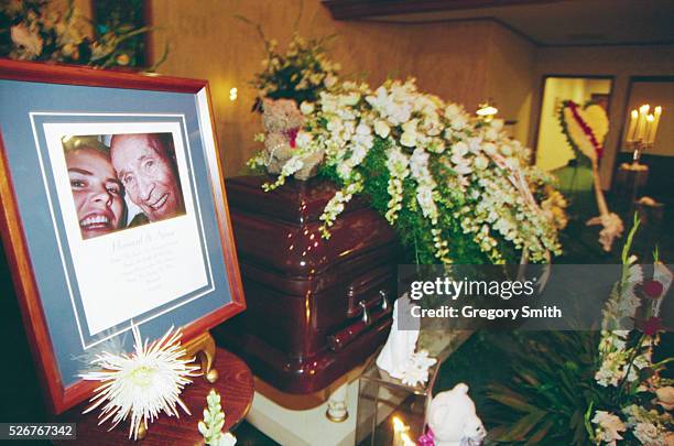 Photograph of Anna Nicole Smith and J. Howard Marshall II sits next to Marshall's casket. Anna Nicole Smith attends the memorial service for her...