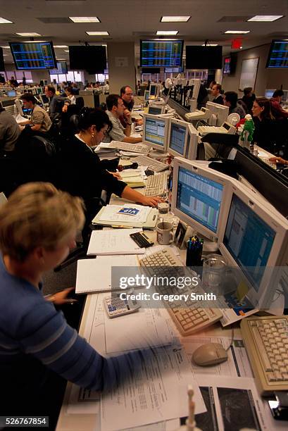 Employees working at their computers on the gas trading floor of the giant energy corporation Enron.