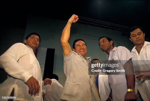 General Manuel Noriega raises his fist as he is surrounded by supporters. Photo taken in February 1988.