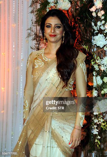 Indian Bollywood actress Tabu poses as she attends a reception after the wedding of fellow thespians Bipasha Basu and Karan Singh Grover in Mumbai...