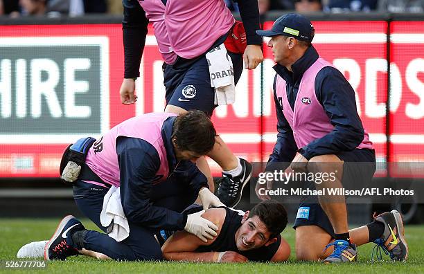 Jacob Weitering of the Blues lays injured during the 2016 AFL Round 06 match between the Carlton Blues and the Essendon Bombers at the Melbourne...