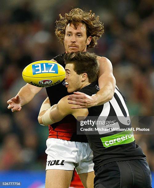 Mitch Brown of the Bombers is tackled by Lachie Plowman of the Blues during the 2016 AFL Round 06 match between the Carlton Blues and the Essendon...