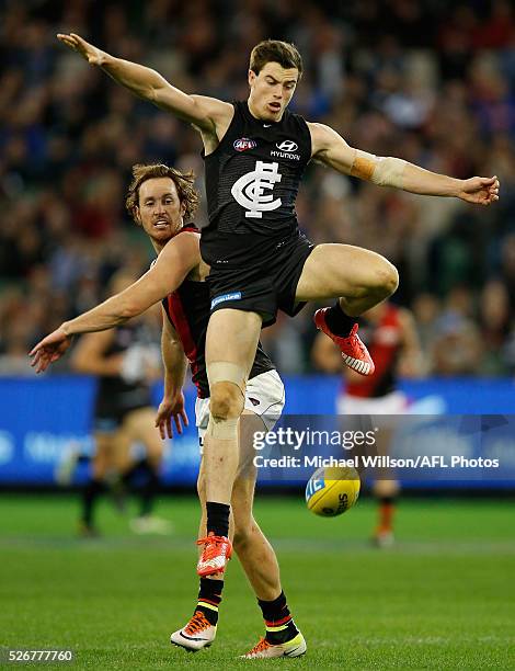 Mitch Brown of the Bombers and Lachie Plowman of the Blues in action during the 2016 AFL Round 06 match between the Carlton Blues and the Essendon...