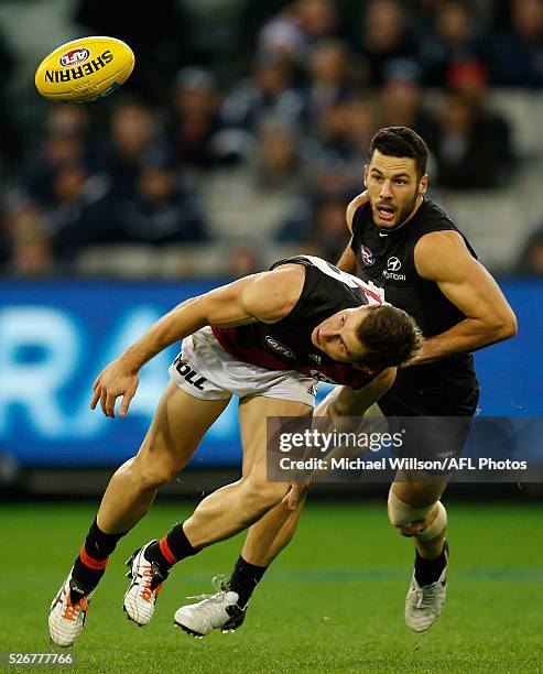 James Polkinghorne of the Bombers and Simon White of the Blues in action during the 2016 AFL Round 06 match between the Carlton Blues and the...