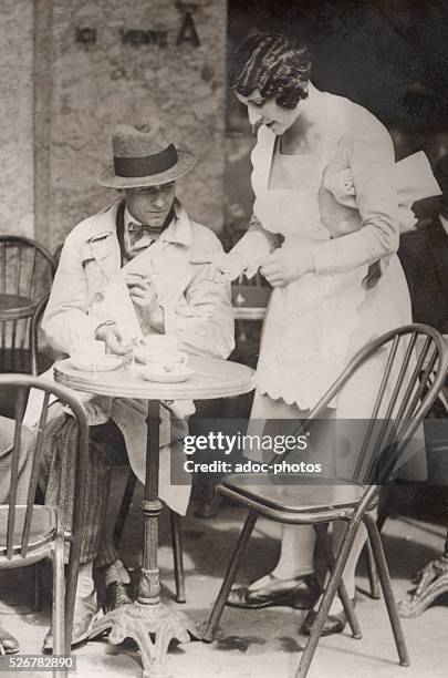 Waitress at a cafe terrace in Paris . In August 1930.