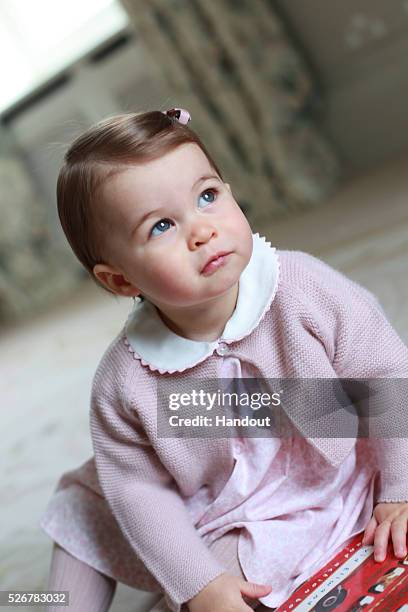 In this undated handout photo provided by HRH The Duke and Duchess of Cambridge released on May 1 Princess Charlotte of Cambridge looks up as her...