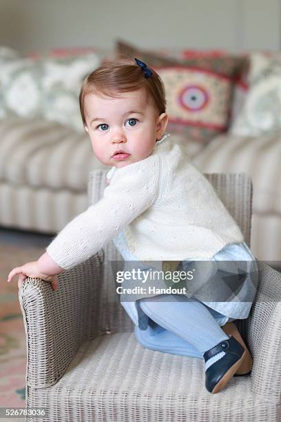 In this undated handout photo provided by HRH The Duke and Duchess of Cambridge released on May 1 Princess Charlotte of Cambridge looks up on a chair...