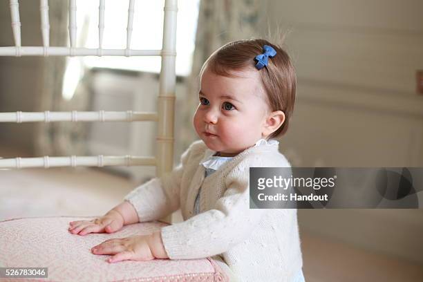 In this undated handout photo provided by HRH The Duke and Duchess of Cambridge released on May 1 Princess Charlotte of Cambridge looks up with her...