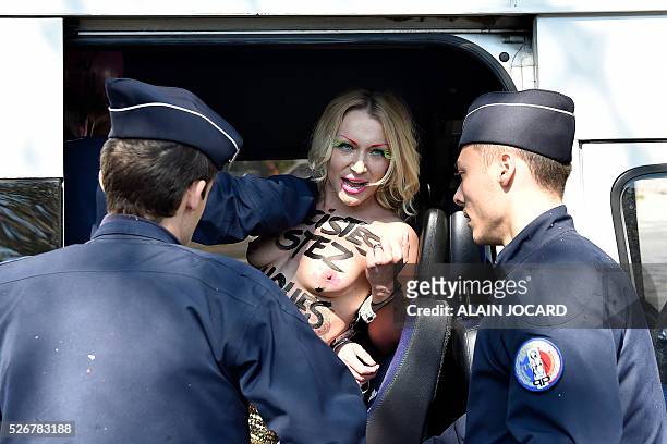 French police officers detain Femen activist Inna Shevchenko during a protest outside a banquet held by France's far-right Front National party in...