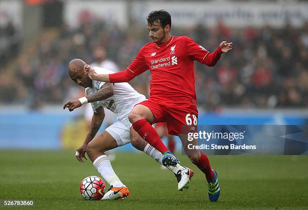 Pedro Chirivella of Liverpool is closed down by Andre Ayew of Swansea City during the Barclays Premier League match between Swansea City and...