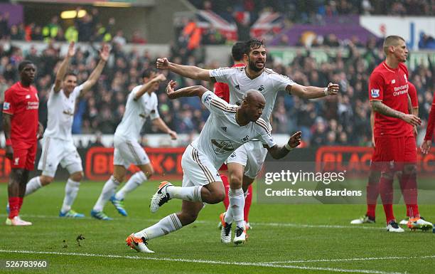 Andre Ayew of Swansea City celebrates scoring the opening goal during the Barclays Premier League match between Swansea City and Liverpool at The...