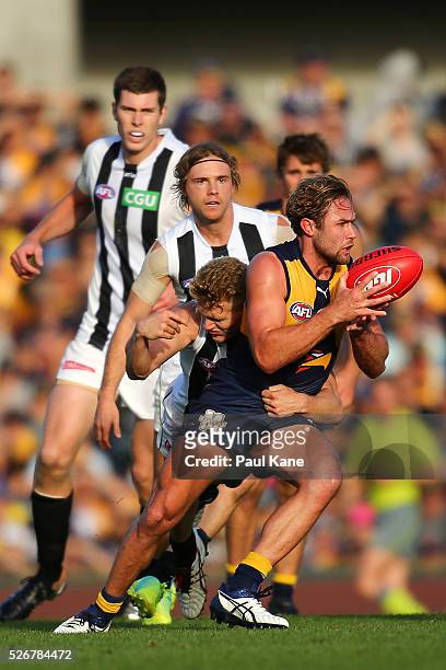 Mark Hutchings of the Eagles gets tackled by Adam Treloar of the Magpies during the round six AFL match between the West Coast Eagles and the...