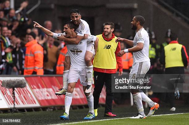 Jack Cork of Swansea City celebrates scoring his team's second goal with Neil Taylor and Ashley Williams during the Barclays Premier League match...
