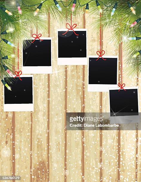 christmas lights evergreen hintergrund polaroids auf holz - fußleiste stock-grafiken, -clipart, -cartoons und -symbole