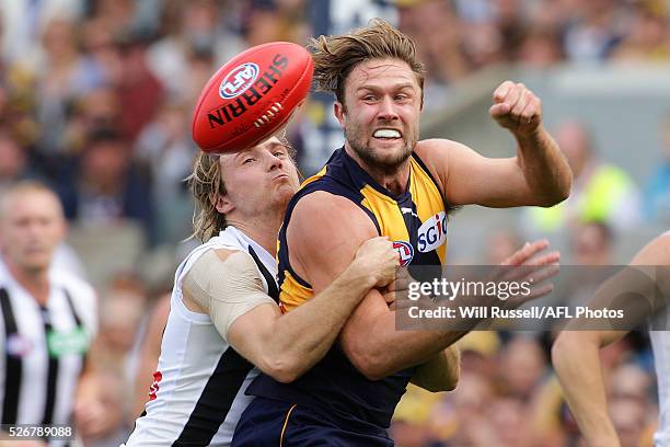 Mark Hutchings of the Eagles handballs under pressure from Ben Sinclair of the Magpies during the round six AFL match between the West Coast Eagles...