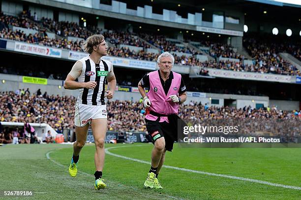 Ben Sinclair of the Magpies leaves the ground for a concussion test during the round six AFL match between the West Coast Eagles and the Collingwood...