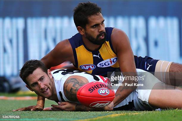 Lewis Jetta of the Eagles tackles Jeremy Howe of the Magpies across the boundary line during the round six AFL match between the West Coast Eagles...