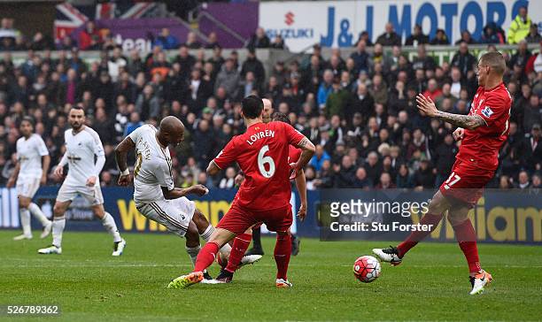 Andre Ayew of Swansea City scores his team's third goal during the Barclays Premier League match between Swansea City and Liverpool at The Liberty...