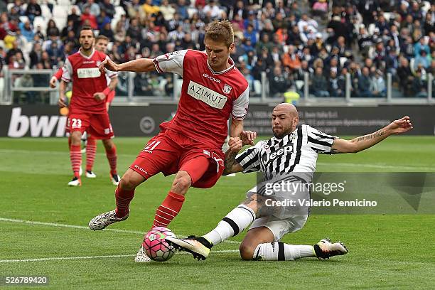 Simone Zaza of Juventus FC is tackled by Simone Romagnoli of Carpi FC during the Serie A match between Juventus FC and Carpi FC at Juventus Arena on...