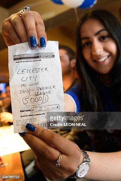 Student Karishma Kapoor holds her betting slip with odds of 5000/1 if Leicester City win the Premiership title, ahead of watching the Leicester City...