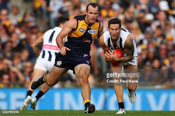 Jeremy Howe of the Magpies marks the ball against Shannon Hurn of the Eagles during the round six AFL match between the West Coast Eagles and the...