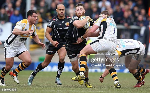 Luke Cowan-Dickie of Exeter is tackled by Matt Mullan and George Smith during the Aviva Premiership match between Exeter Chiefs and Wasps at Sandy...