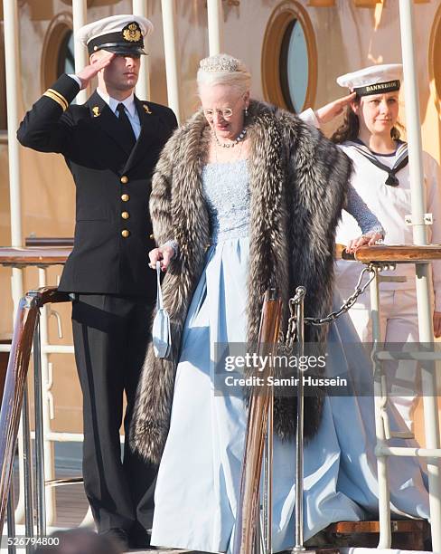 Queen Margrethe of Denmark leaves the Danish Royal Yacht, The Dannebrog to attend a banquet to celebrate the 70th birthday of King Carl Gustaf of...