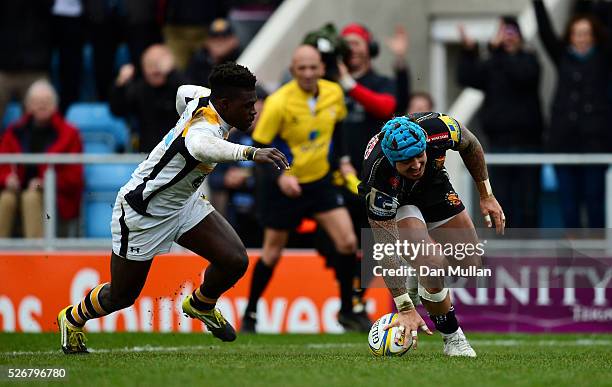 Jack Nowell of Exeter Chiefs scores his side's third try past Christian Wade of Wasps during the Aviva Premiership match between Exeter Chiefs and...