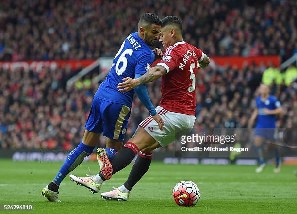 Marcos Rojo of Manchester United challenges Riyad Mahrez of Leicester City in the penalty area during the Barclays Premier League match between...