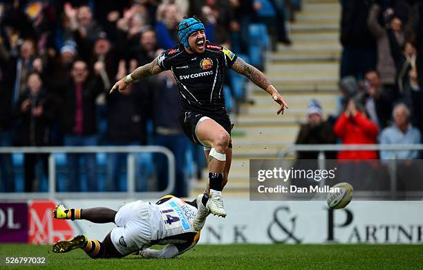 Jack Nowell of Exeter Chiefs celebrates scoring his side's third try past Christian Wade of Wasps during the Aviva Premiership match between Exeter...