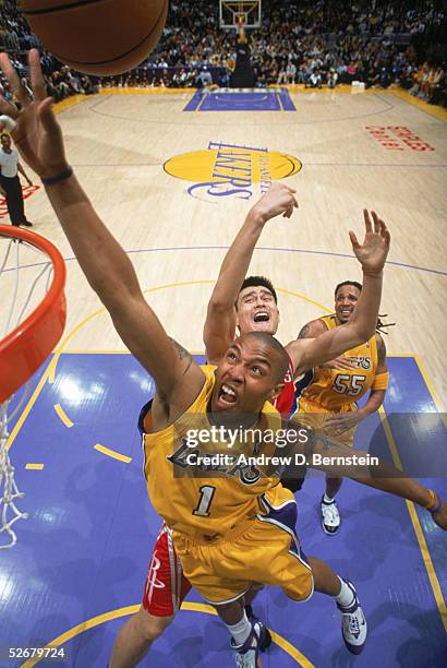 Caron Butler of the Los Angeles Lakers goes to the basket past Yao Ming of the Houston Rockets during a game at Staples Center on April 7, 2005 in...