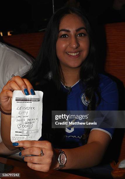 Karishma Kapoor a Leicester City supporter shows off her betting slip as Leicester City fans gather in the Local Hero pub to watch their match...