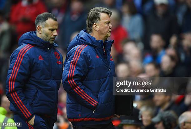 Louis van Gaal, manager of Manchester United and assistant Ryan Giggs walk in for half time during the Barclays Premier League match between...
