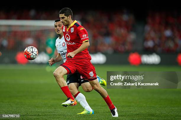 Iacopo La Rocca of United and Mark Bridge of Wanderers challenge for the ball during the 2015/16 A-League Grand Final match between Adelaide United...