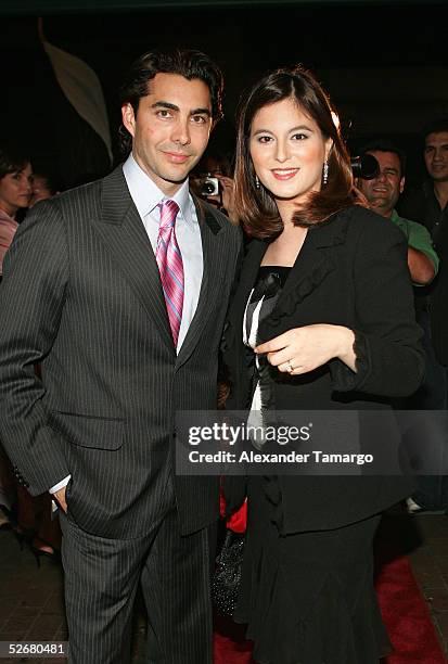 Fashion designer Nicolas Felizola and singer and actress Chabeli Iglesias arrive at the grand opening of the Nicolas Felizola store on April 21, 2005...