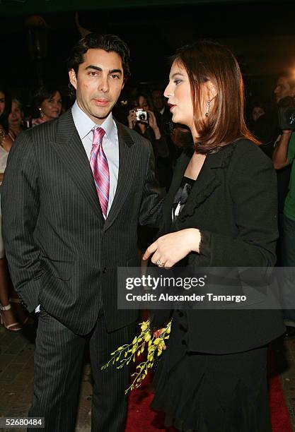 Fashion designer Nicolas Felizola and singer and actress Chabeli Iglesias arrive at the grand opening of the Nicolas Felizola store on April 21, 2005...