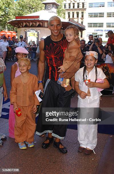 Soccer star David James is accompanied by a group of children at the premiere of "Spy Kids 2: Island of Lost Dreams" at the Odeon West End.