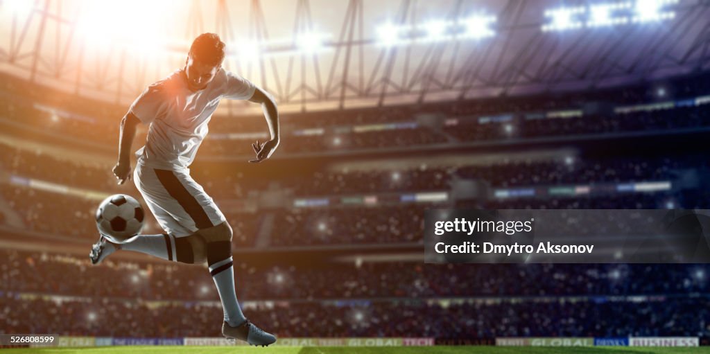 Soccer Player Kicking Ball on stadium