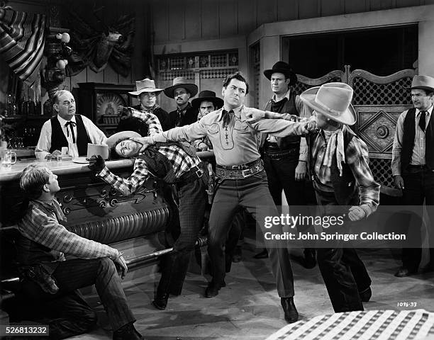 Tom Bryant holds off the outlaws in a saloon fight. From the 1940 motion picture Boss of Bullion City.